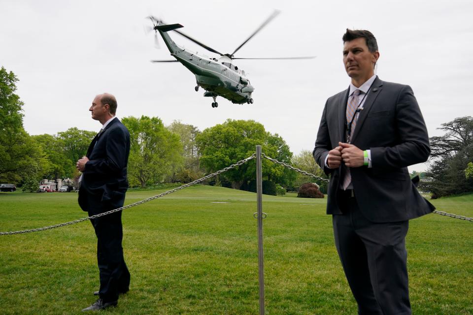 Members of the U.S. Secret Service stand guard as Marine One, with President Joe Biden aboard, lifts off from the South Lawn of the White House May 1 in Washington.