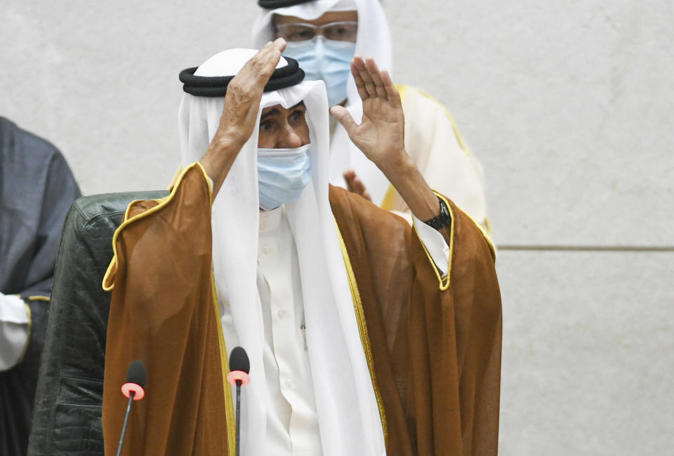 The new Emir of Kuwait Sheikh Nawaf Al Ahmad Al Sabah, waves after he performed the constitutional oath at the Kuwaiti National Assembly in Kuwait, Wednesday, Sept. 30, 2020. Kuwait's Sheikh Nawaf was sworn in Wednesday as the ruling emir of the tiny oil-rich country, propelled to power by the death of his half-brother after a long career in the security services. (AP Photo/Jaber Abdulkhaleg)