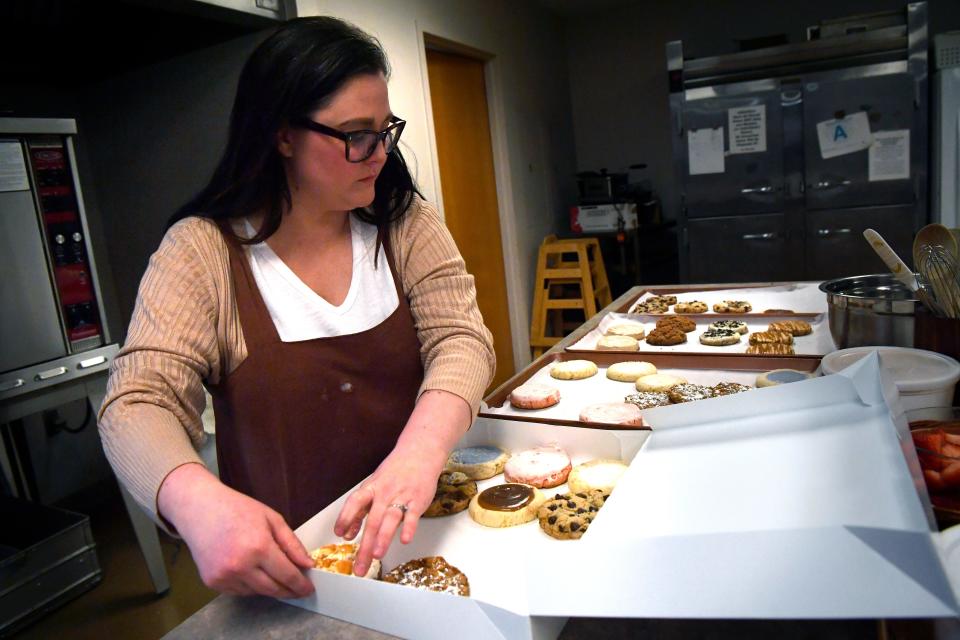 Christine Pinson places cookies into a sampler box Thursday. The owner of Hey Sugar, a specialty cookie business, rents the Highland Church of Christ commercial kitchen for large orders.