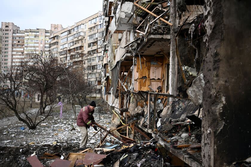 TOPSHOT - A man clears debris at a damaged residential building at Koshytsa Street, a suburb of the Ukrainian capital Kyiv, where a military shell allegedly hit, on February 25, 2022. - Russian forces reached the outskirts of Kyiv on Friday as Ukrainian President Volodymyr Zelensky said the invading troops were targeting civilians and explosions could be heard in the besieged capital. Pre-dawn blasts in Kyiv set off a second day of violence after Russian President Vladimir Putin defied Western warnings to unleash a full-scale ground invasion and air assault on Thursday that quickly claimed dozens of lives and displaced at least 100,000 people. (Photo by Daniel LEAL / AFP) (Photo by DANIEL LEAL/AFP via Getty Images)