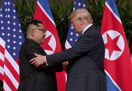 U.S. President Donald Trump shakes hands with North Korean leader Kim Jong Un at the Capella Hotel on Sentosa island in Singapore June 12, 2018. REUTERS/Jonathan Ernst