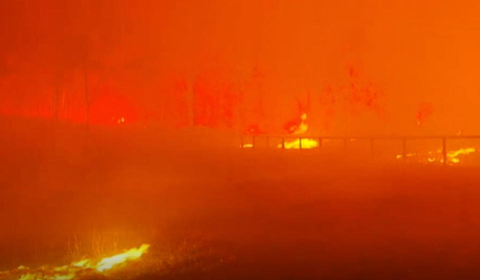 Bushfires are seen turning the sky orange as they destroy parts of Rappville.