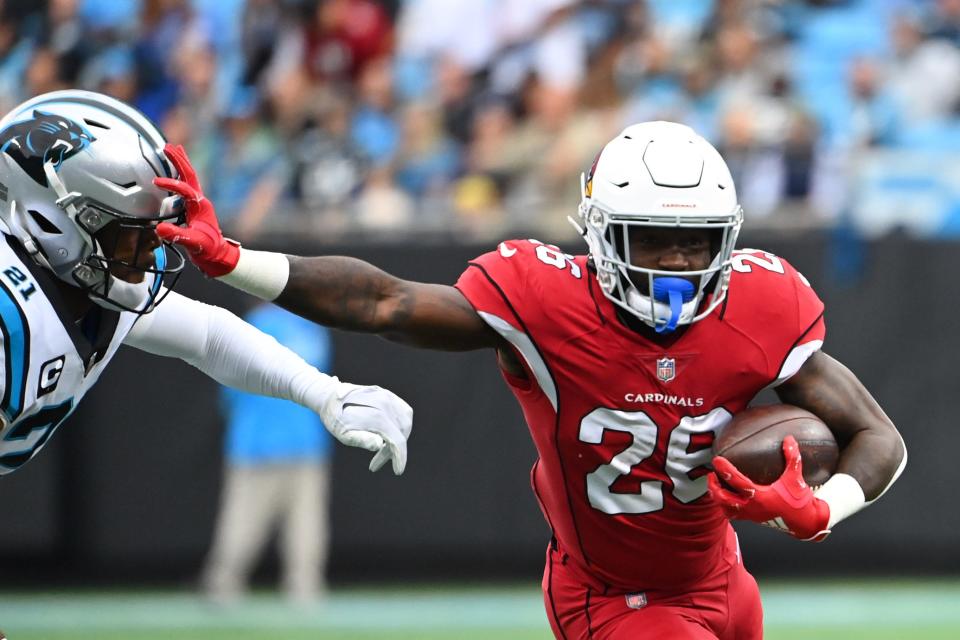 Oct 2, 2022; Charlotte, North Carolina, USA; Arizona Cardinals running back Eno Benjamin (26) with the ball as Carolina Panthers safety Jeremy Chinn (21) defends in the first quarter at Bank of America Stadium. Mandatory Credit: Bob Donnan-USA TODAY Sports