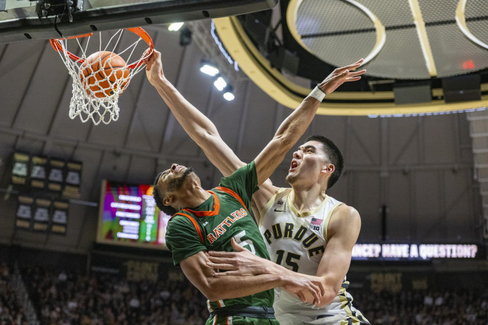 Purdue center Zach Edey (15) scores while being defended by Florida A&M forward Jaylen Bates (5) during the second half of an NCAA college basketball game Thursday, Dec. 29, 2022, in West Lafayette, Ind. (AP Photo/Doug McSchooler)