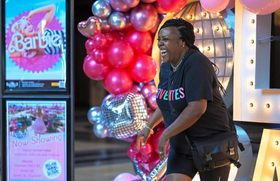 Barbie fan Kendra Morris of Kansas City, laughed after posing for photos at the Barbie-themed Alph-lit display on Thursday, July 20, 2023 at Union Station. Tammy Ljungblad/tljungblad@kcstar.com