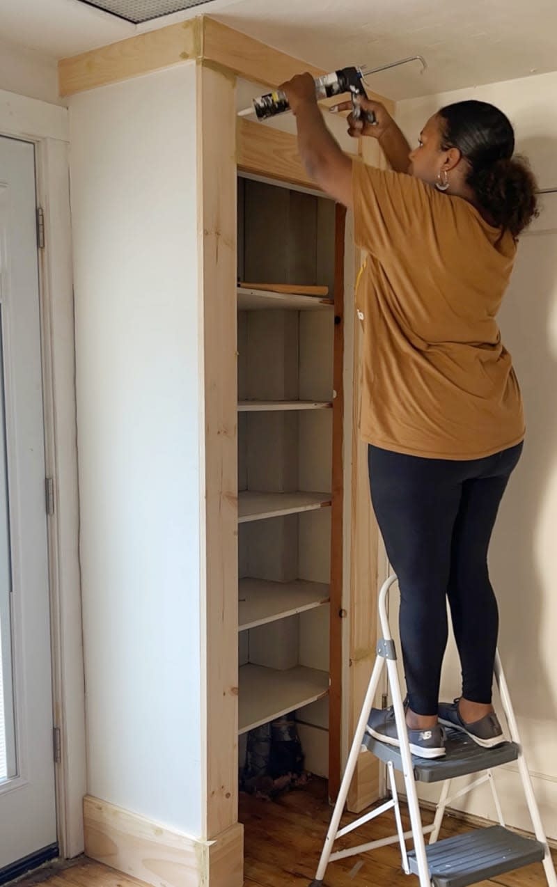 Caulking the seams between wood trim and wall