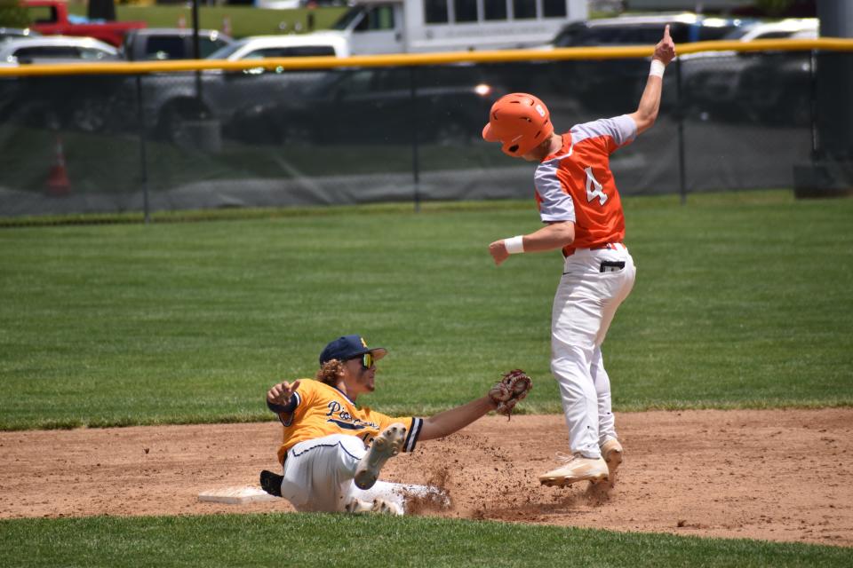 Mooresville's Hogan Denny tries to tag out a juking William Rieckers during the Pioneers' regional game with Columbus East on June 4, 2022.
