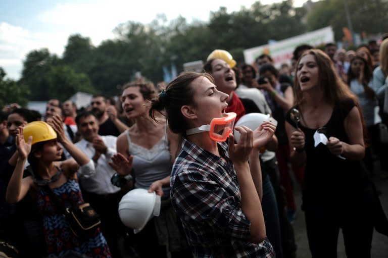 Protesters shout slogans during a demonstration in Gazi Park, next to Taksim Square, in Istanbul on June 7, 2013. Hotel reservations may be down after a week of violent mass protests in Turkey, but plucky tourists on the ground have taken the unrest in their stride