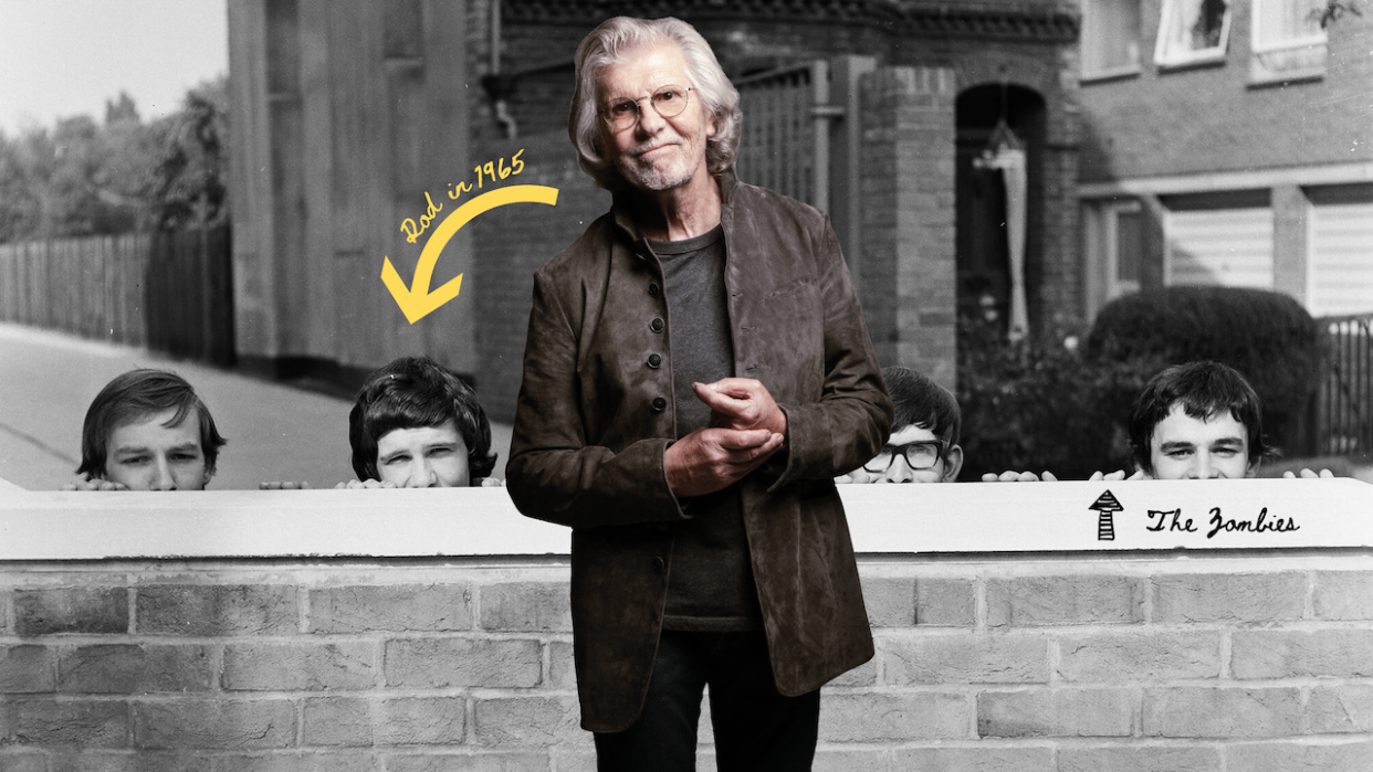  Rod Argent standing in front of a 60s picture of the Zombies 