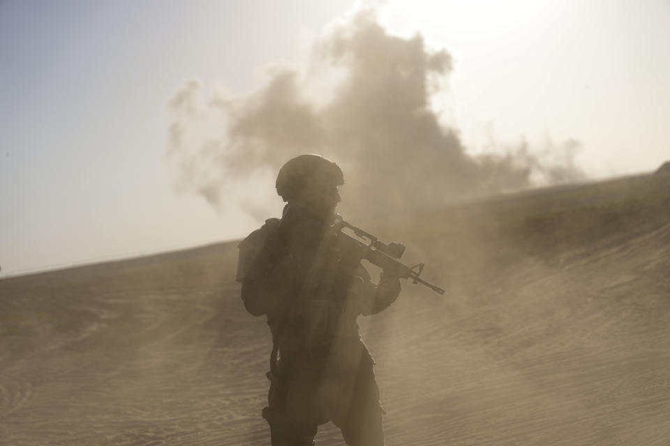 An Israeli soldier stands near the Gaza Strip border in southern Israel, Monday, March 4, 2024. The army is battling Palestinian militants across Gaza in the war ignited by Hamas' Oct. 7 attack into Israel. (AP Photo/Ohad Zwigenberg)