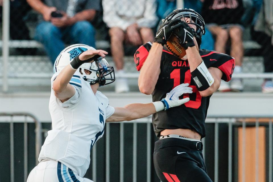 New Philadelphia's Owen Schoelles makes a leaping catch to set up a touchdown conversion to tie the game 14-14 against Louisville, Friday, Aug. 18 at Woody Hayes Quaker Stadium in New Philadelphia.