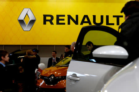 FILE PHOTO: People look on Renault cars during the international motor show Auto 2019 in Riga, Latvia April 13, 2019. REUTERS/Ints Kalnins/File Photo