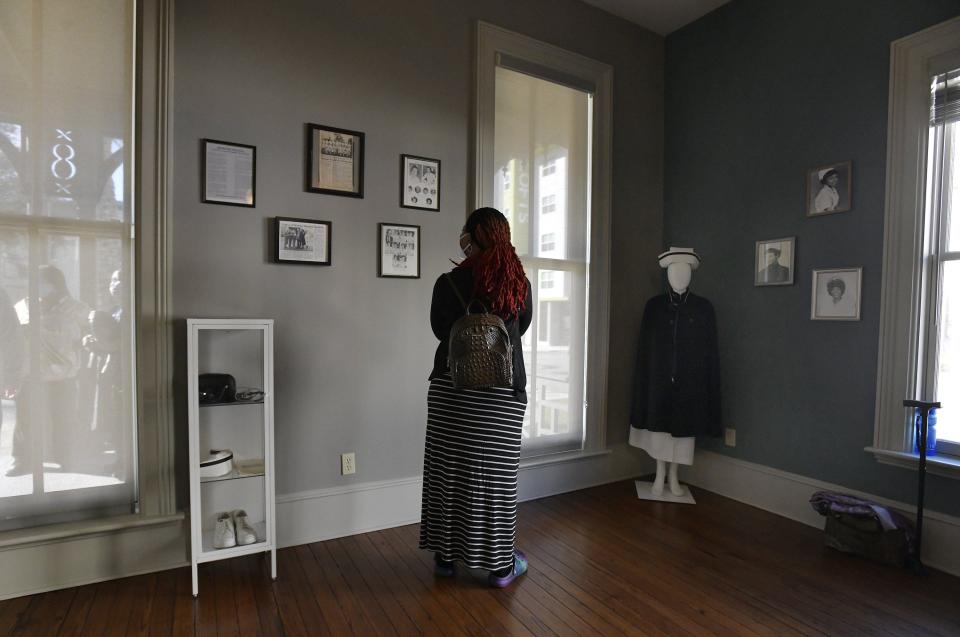 A visitor looks over artifacts and articles chronicling some of the history of the Brewster-Duval School of Nursing that is now part of a gallery inside the historic Brewster Hospital building on West Monroe Street in Jacksonville's LaVilla neighborhood. Among those who showed up at Thursday's opening were a number of the African American nurses who trained there in the late 1950s and early 1960s. The building now serves as the headquarters of the North Florida Land Trust.