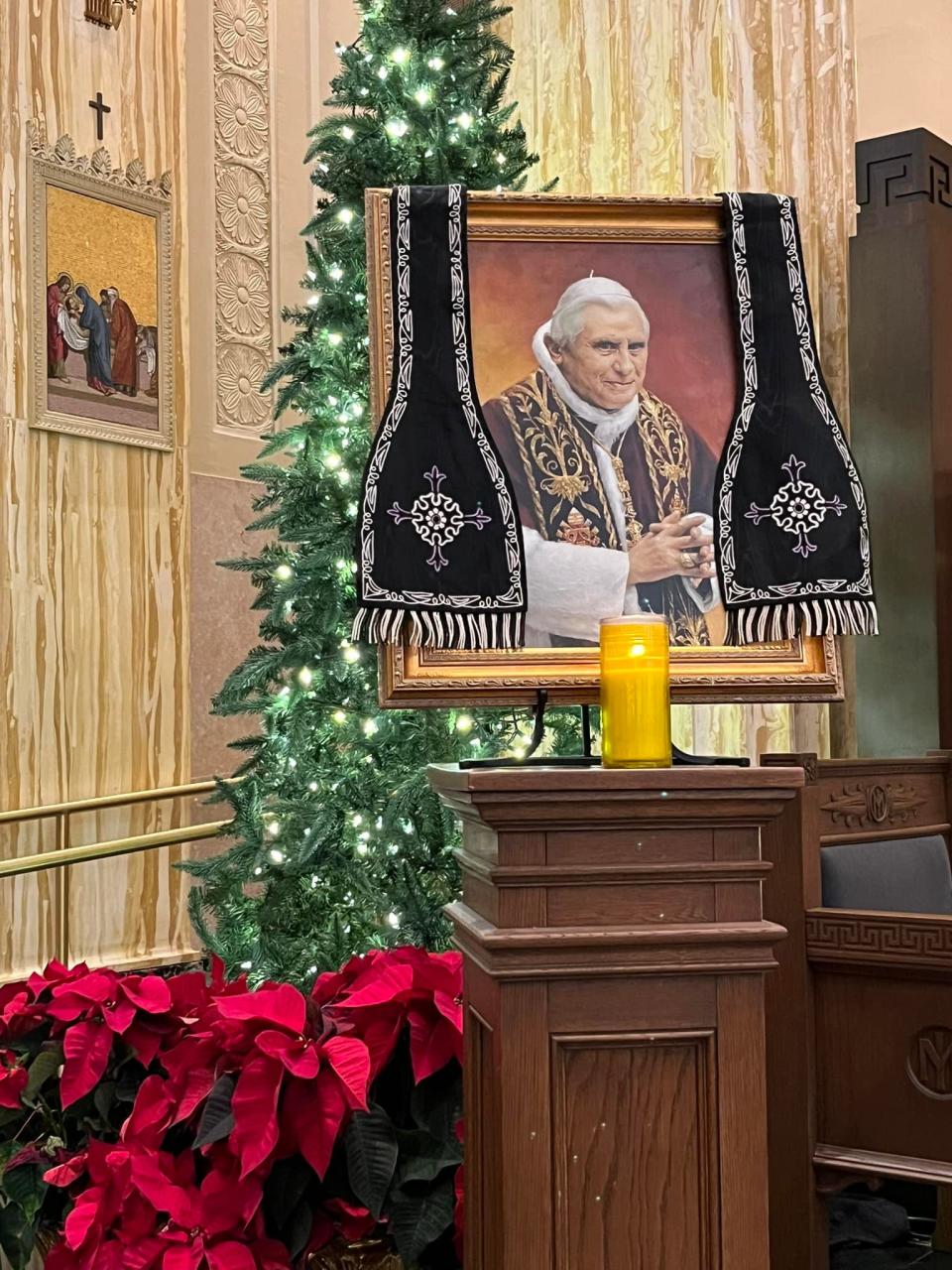 A picture of the late Pope Emeritus Benedict XVI is positioned by the bishop's chair at the Cathedral of the Immaculate Conception in Springfield. The former pope, who made history by resigning in 2013, died Saturday.