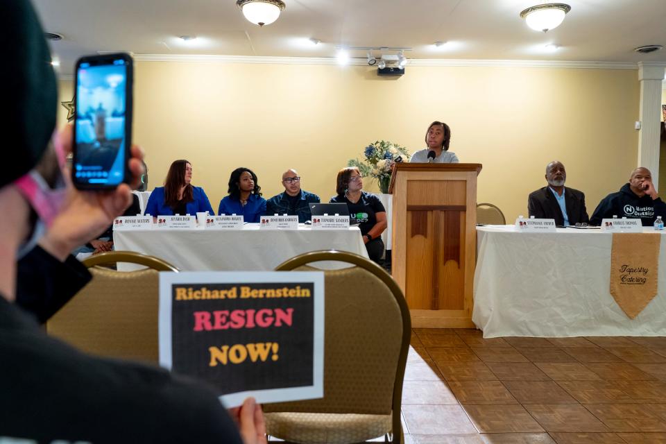 Jimmy Thomas of Wyandotte holds a sign stating "Richard Bernstein Resign Now" as Stephanie Crider of Agape Social Justice speaks while community organizers advocating for the formerly incarcerated call for Michigan Supreme Court Justice Richard Bernstein to make amends with the community, condemning his comments about Justice Kyra Bolden's hiring of law clerk Peter Martel, who once served 14 years in prison for robbing a Flint-area store and shooting at police officers during a press conference at the Tapestry Event Hall in Southfield on January 12, 2023. Martel quickly resigned after Bernstein said he was "disgusted" by the hire.