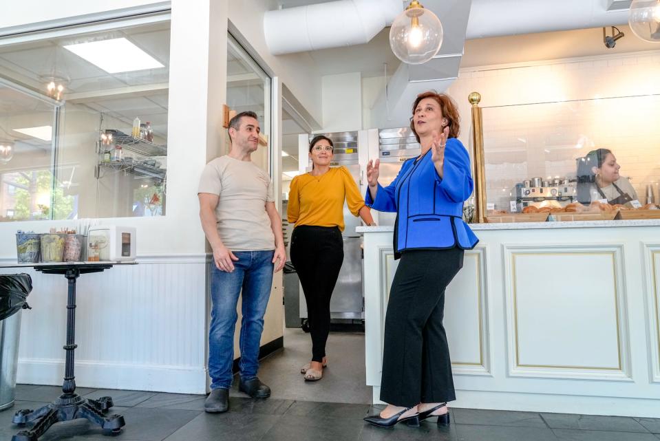 Nellie Gorbea chats with Sergio Mendoza and Hercilia Corona, owners of Madrid European Bakery and Patisserie in Providence's Wayland Square.