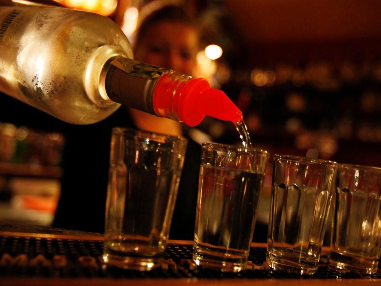 A bartender serves alcohol at a bar in Prague September 12, 2012.