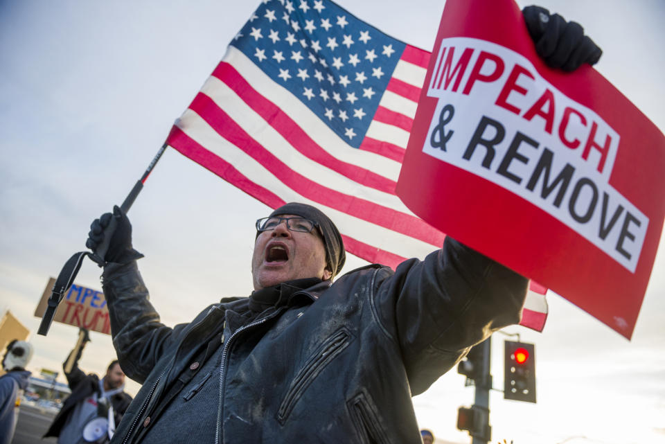 Kenneth Thorstensen shouts for the impeachment of President Donald Trump during a march along Bear Valley Road in Victorville, Calif., on Tuesday, Dec. 17, 2019. Demonstrators on both sides of the impeachment issue lined both sides of Bear Valley Road over the Interstate 15.Tuesday, Dec. 17, 2019. (James Quigg/The Daily Press via AP)