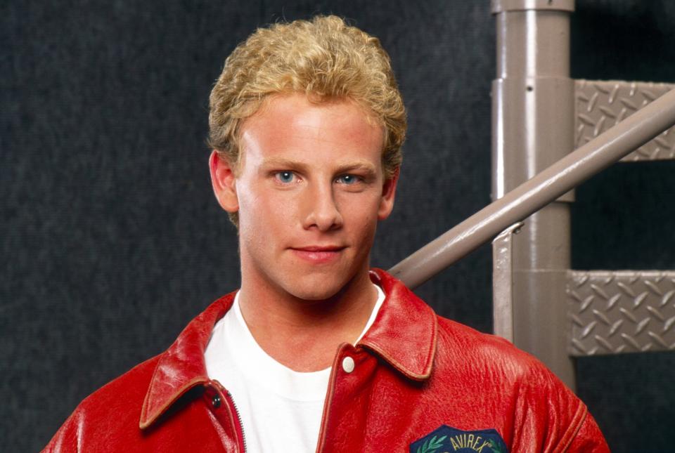 Actor in a red jacket with "California University" emblem, from a 90s TV show