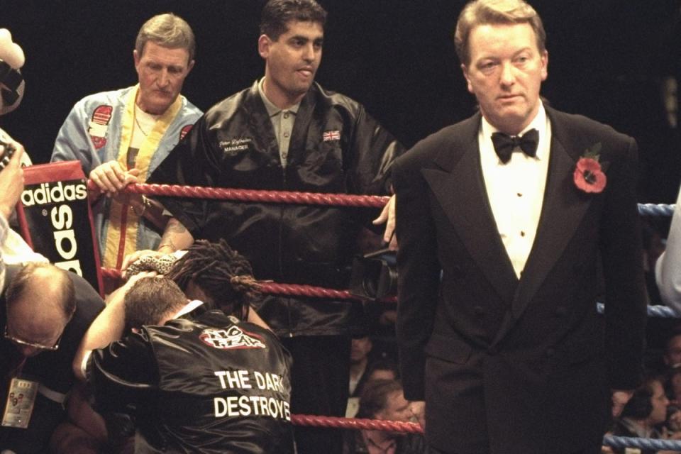Warren in the corner of a beaten Nigel Benn in 1996 (Getty)