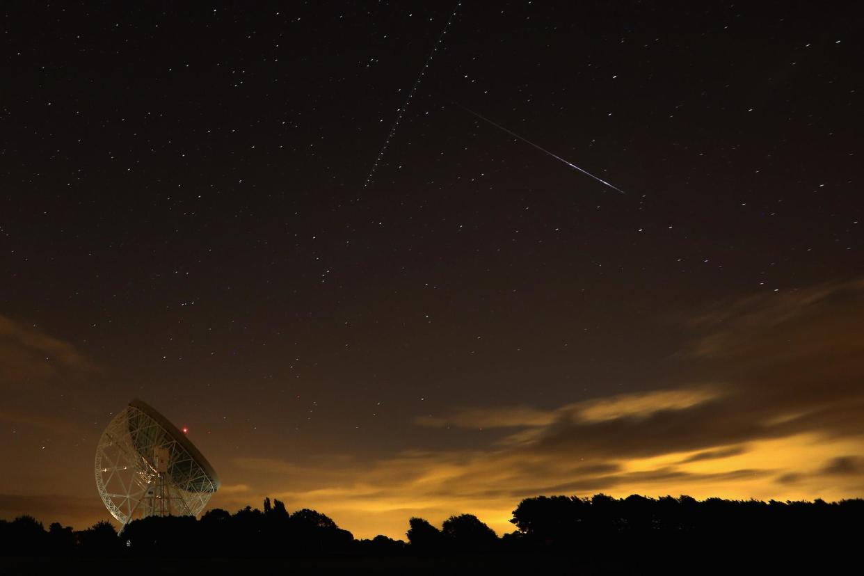 A Perseid meteor streaks across the sky over the Lovell Radio Telescope at Jodrell Bank on August 13, 2013 in Holmes Chapel, United Kingdom: Getty Images