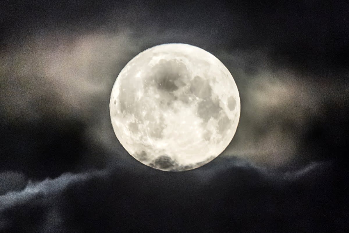 File image dated: Tuesday June 14, 2022, which shows the strawberry supermoon setting behind a cloud above Huddersfield in Yorkshire. Another supermoon is expected on July 13, 2022 (Danny Lawson/PA) (PA Wire)