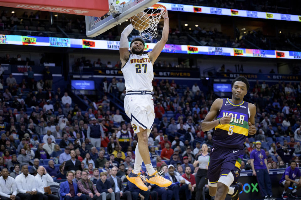 Denver Nuggets guard Jamal Murray (27) dunks against New Orleans Pelicans forward Herbert Jones (5) in the second half of an NBA basketball game in New Orleans, Tuesday, Jan. 24, 2023. (AP Photo/Matthew Hinton)