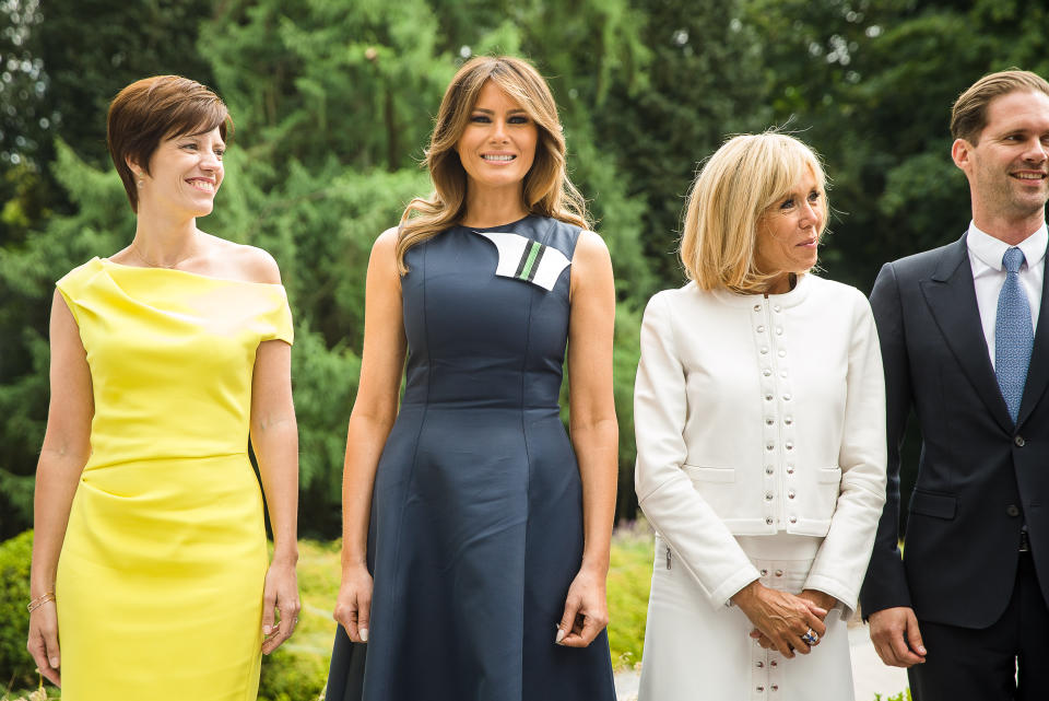 For a meeting with state officials, including the French President and his wife, Melania decided on a navy blue dress by Calvin Klein which featured detail at the neck. [Photo: Rex]