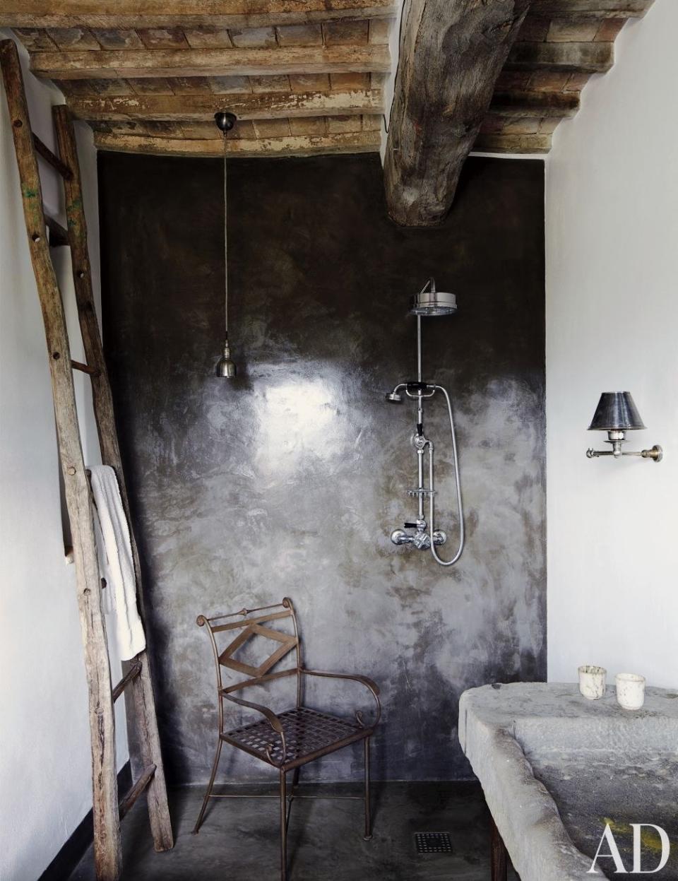 A guest bath in a <a rel="nofollow noopener" href="https://www.architecturaldigest.com/story/architect-benedikt-bolza-umbria-italy-farmhouse-article?mbid=synd_yahoo_rss" target="_blank" data-ylk="slk:home in Umbria, Italy;elm:context_link;itc:0;sec:content-canvas" class="link ">home in Umbria, Italy</a>, has a concrete-and-resin shower with Lefroy Brooks fittings; the stone sink is antique. <strong>Related:</strong> <a rel="nofollow noopener" href="https://www.architecturaldigest.com/decorating-with-color?mbid=synd_yahoo_rss" target="_blank" data-ylk="slk:AD’s Guide to Decorating with Color;elm:context_link;itc:0;sec:content-canvas" class="link "><em>AD</em>’s Guide to Decorating with Color</a>