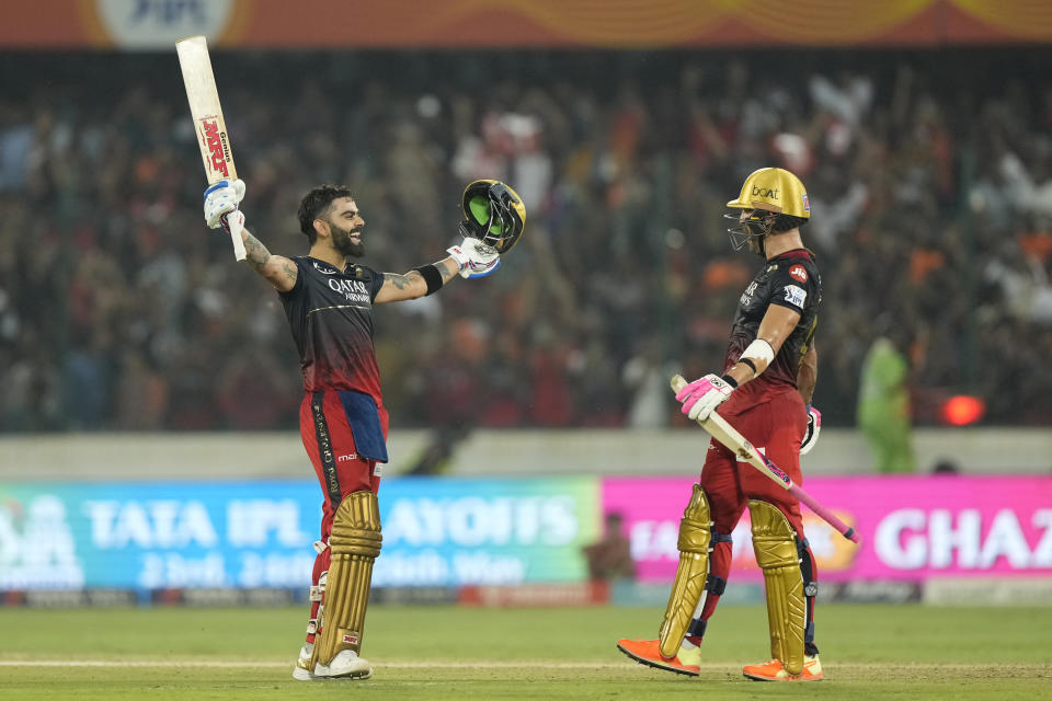 Royal Challengers Bangalores' Virat Kohli, left, celebrates scoring a century as Faf du Plessis watches during the Indian Premier League cricket match between Sunrisers Hyderabad and Royal Challengers Bangalore in Hyderabad, India, Thursday, May 18, 2023. (AP Photo/Mahesh Kumar A.)