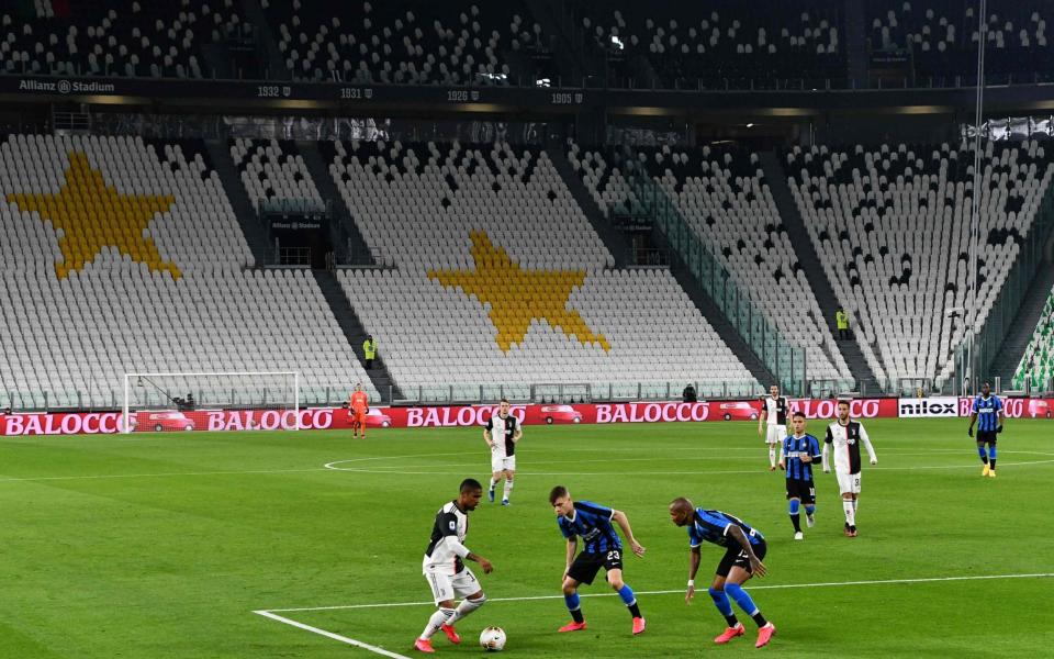 Juventus' forward Douglas Costa (L) vies with Inter Milan's Nicolo Barella (C) and Ashley Young - AFP