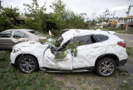 <p>An SUV damaged by a fallen tree from a tornado is seen in the Arlington Woods neighbourhood of Ottawa, on Sunday, Sept. 23, 2018. The storm tore roofs off of homes, overturned cars and felled power lines in the Ottawa community of Dunrobin and in Gatineau, Que. A second tornado also hit the Nepean neighbourhood of Arlington Woods. (Photo from Justin Tang/The Canadian Press) </p>