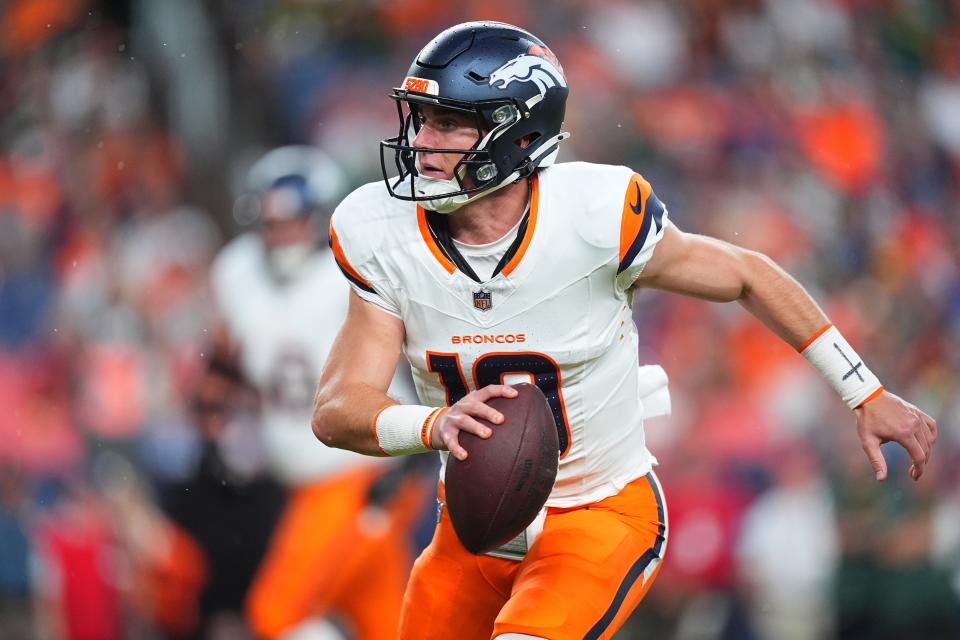 Aug 18, 2024; Denver, Colorado, USA; Denver Broncos quarterback Bo Nix (10) scrambles with the ball in the first quarter against the Green Bay Packers at Empower Field at Mile High. Mandatory Credit: Ron Chenoy-USA TODAY Sports ORG XMIT: IMAGN-880858 ORIG FILE ID: 20240818_tbs_ac4_101.JPG