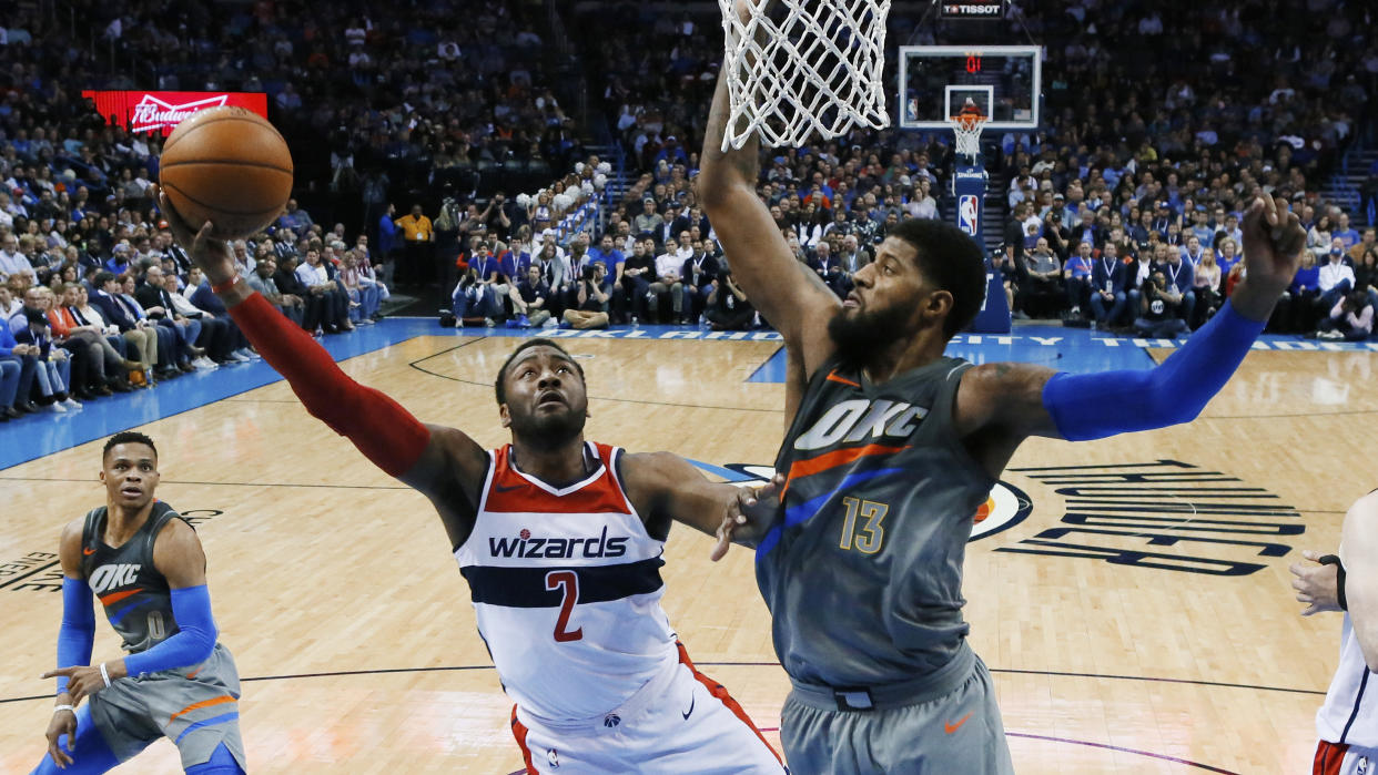 John Wall and Marcin Gortat won’t be each other’s Valentines, but that’s OK. (AP Foto/Sue Ogrocki)