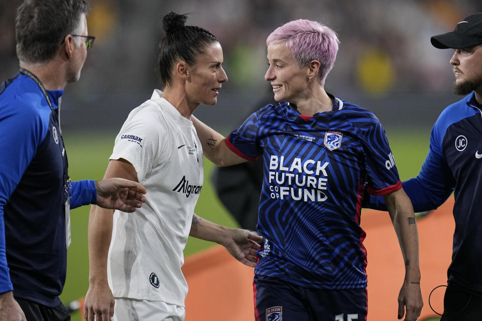 OL Reign forward Megan Rapinoe, right, speaks with NJ/NY Gotham defender Ali Krieger as Rapinoe comes off the field after an injury during the first half of the NWSL Championship soccer game, Saturday, Nov. 11, 2023, in San Diego. (AP Photo/Gregory Bull)