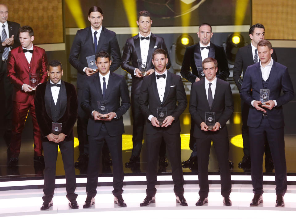 The FIFA "dream team" with the best goal keeper, defenders, midfielders and forwards stands on the stage at the FIFA Ballon d'Or 2013 Gala in Zurich, Switzerland, Monday, Jan. 13, 2014. (AP Photo/Michael Probst) Front row from left: Daniel Alves, Barcelona and Brazil, Thiago Silva, Paris Saint-Germain and Brazil, Sergio Ramos, Real Madrid and Spain, Philipp Lahm, Bayern Munich and Germany, Manuel Neuer, Bayern Munich and Germany, back row from left: Lionel Messi, Barcelona and Argentina, Zlatan Ibrahimovic, Paris Saint-Germain, Cristiano Ronaldo, Real Madrid and Portugal, Franck Ribery, Bayern Munich and Germany and Xavi Hernandez, Barcelona and Spain.