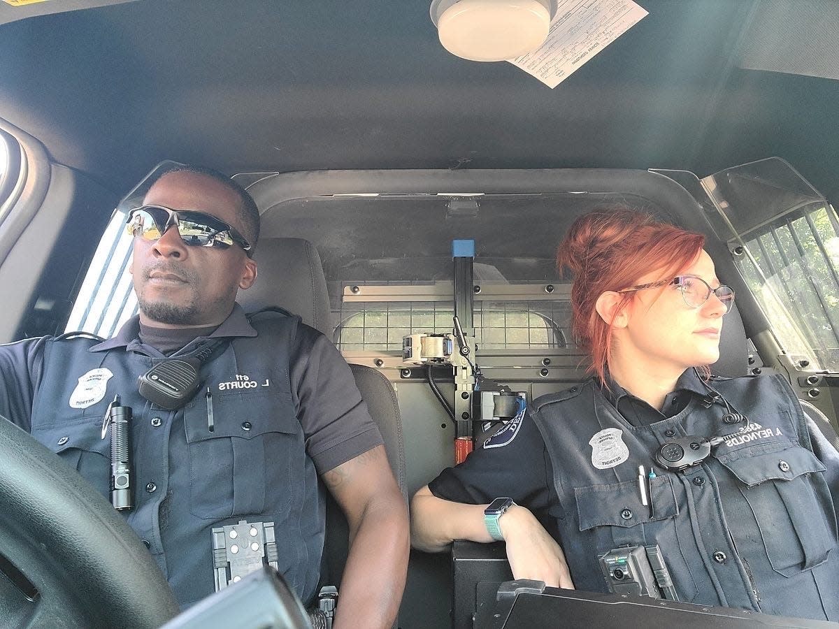 Shelton High School graduate and Detroit Police Officer Amanda Hudgens and Officer Loren Courts in their patrol car.