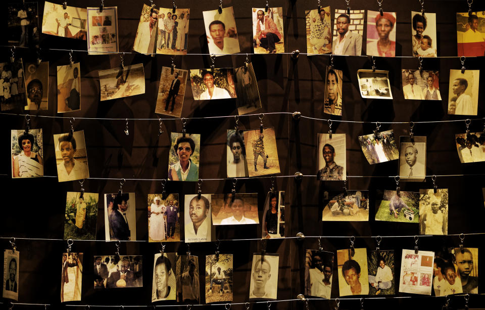 FILE - Family photographs of some of those who died hang on display in an exhibition at the Kigali Genocide Memorial centre in the capital Kigali, Rwanda Friday, April 5, 2019. (AP Photo/Ben Curtis, File)