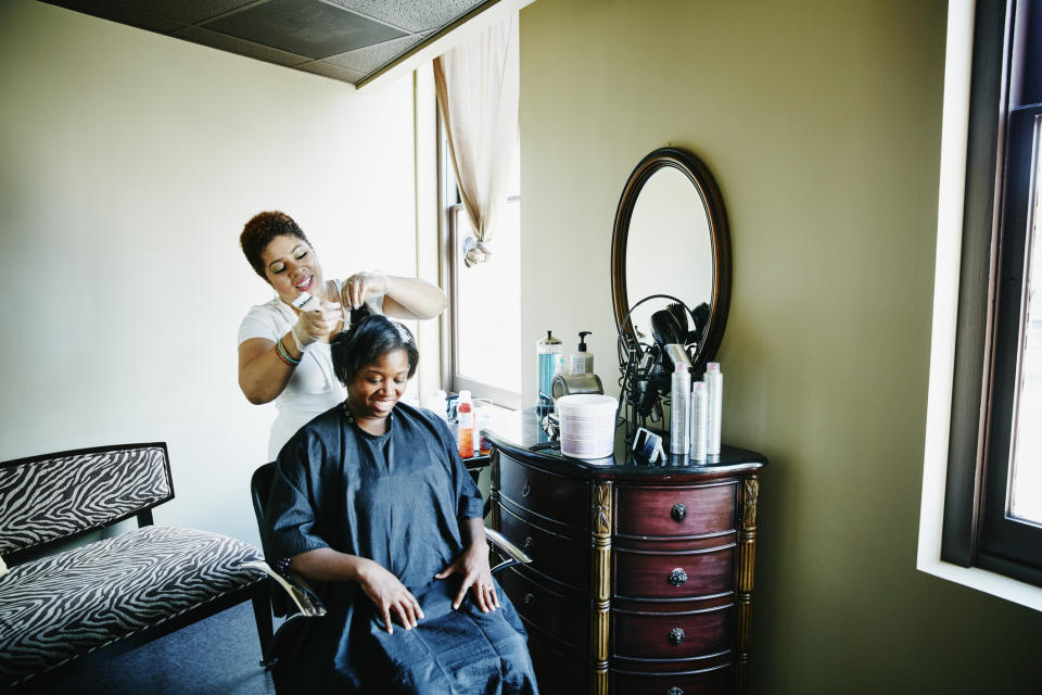 Hairdresser working on a client's hair in a salon setting