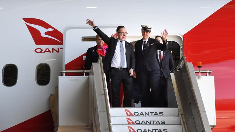 Qantas CEO Alan Joyce and crew members of flight QF7879, which flew direct from London to Sydney, disembark the plane during the Qantas Centenary Launch at Qantas Sydney Jet Base in Sydney