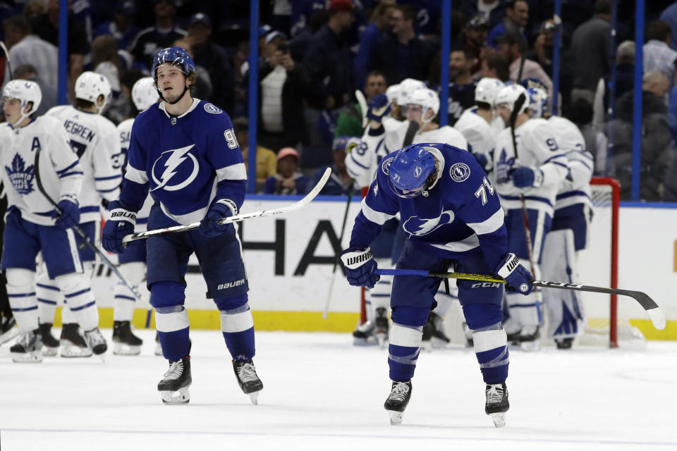 Tampa Bay Lightning center Anthony Cirelli (71) and defenseman Mikhail Sergachev (98) react as the Toronto Maple Leafs celebrate their win over the Lightning during an NHL hockey game Tuesday, Feb. 25, 2020, in Tampa, Fla. (AP Photo/Chris O'Meara)