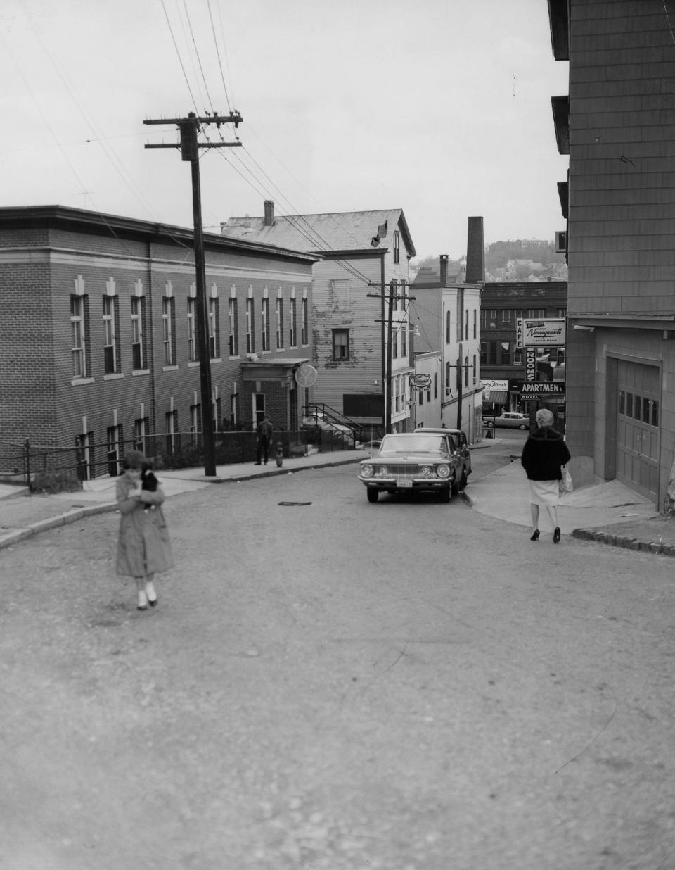 Living in a single rented room was once commonplace in Woonsocket, as evidenced by the sign advertising "Rooms" in this 1962 photo of Ascension Street.