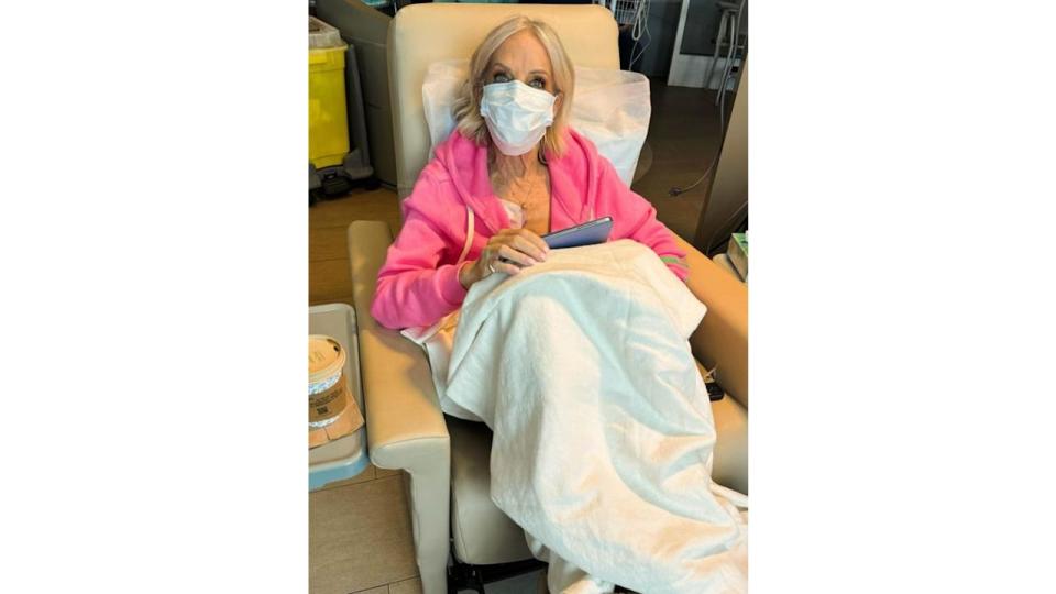 An elderly woman in a hospital with a facemask