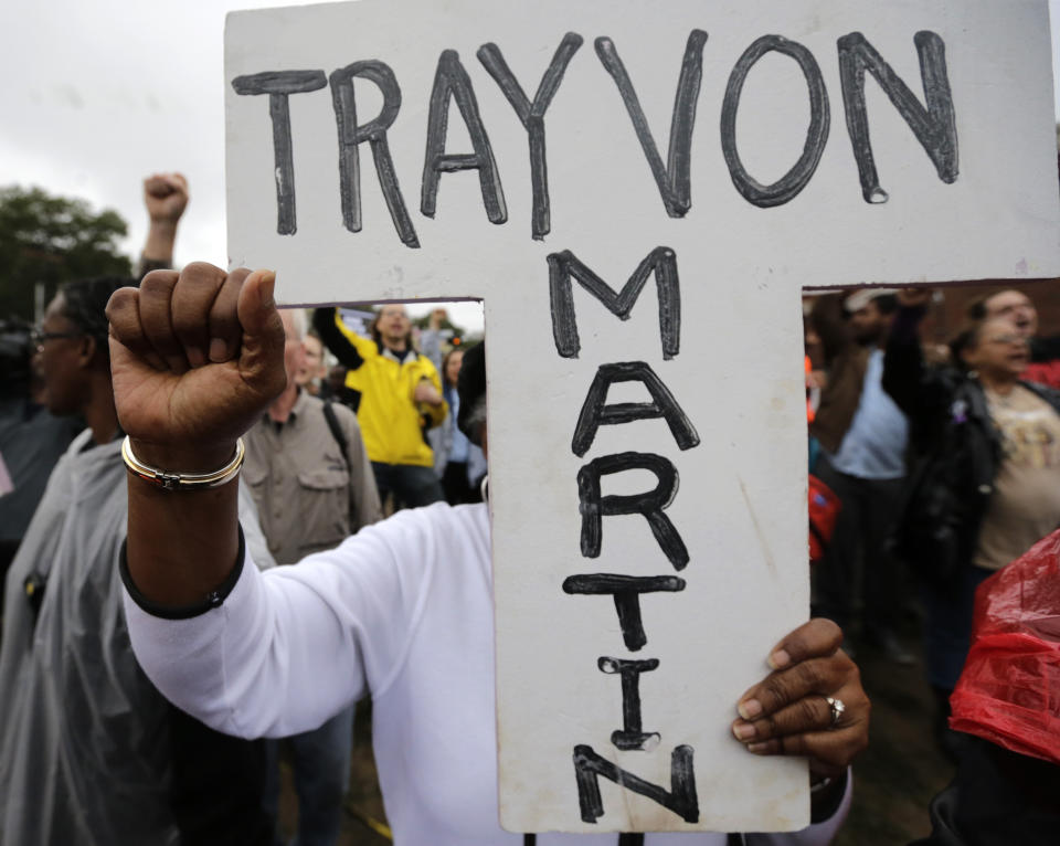 FILE - A protester carries a cross with the name of Trayvon Martin during a march on Oct. 13, 2014, to the Ferguson, Mo., police station to protest the shooting death of 18-year-old Michael Brown in August 2014. The Black Lives Matter movement hits a milestone on Thursday, July 13, 2023, marking 10 years since its 2013 founding in response to the acquittal of the man who fatally shot Martin. The shooting death of Brown at the hands of police in Ferguson, Mo., helped the phrase “Black lives matter” become a potent rallying cry for progressives and a favorite target of derision for law enforcement unions and political conservatives. (AP Photo/Charles Rex Arbogast, File)