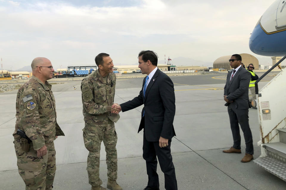 U.S. Defense Secretary Mark Esper, center, is greeted by U.S. military personnel upon arriving in Kabul, Afghanistan, Sunday, Oct. 20, 2019. Esper arrived Sunday in Afghanistan, where stalled peace talks with the Taliban and persistent violent attacks by the insurgent group and Islamic State militants have complicated the Trump administration’s pledge to withdraw more than 5,000 American troops. He told reporters traveling with him that he believes the U.S. can reduce its force in Afghanistan without hurting the counterterrorism fight against al-Qaida and the Islamic State group. (AP Photo/Lolita C. Balbor)