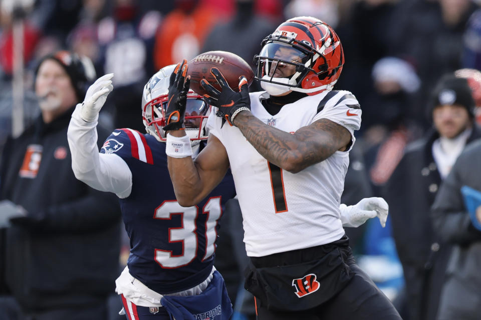 Cincinnati Bengals wide receiver Ja'Marr Chase (1) tries to get a grip on the ball as he is unable to make the catch as New England Patriots cornerback Jonathan Jones (31) defends during the first half of an NFL football game, Saturday, Dec. 24, 2022, in Foxborough, Mass. (AP Photo/Michael Dwyer)