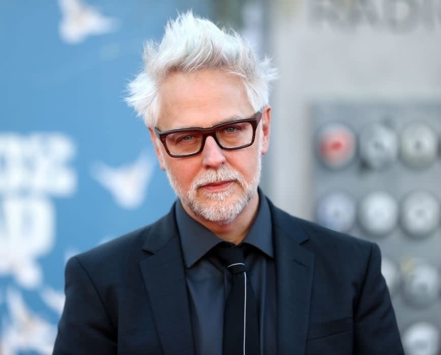 James Gunn with all white hair and beard, wearing glasses