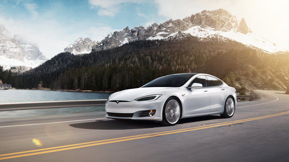 A white Model S driving in the mountains