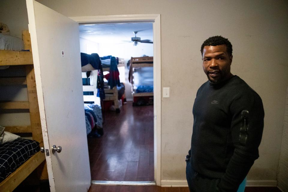 Melvin Cole, founder of PURE Academy, stands in front of one of the living areas filled with bunk beds while giving a tour of the academy in Memphis, Tenn., on Tuesday, March 26, 2024.