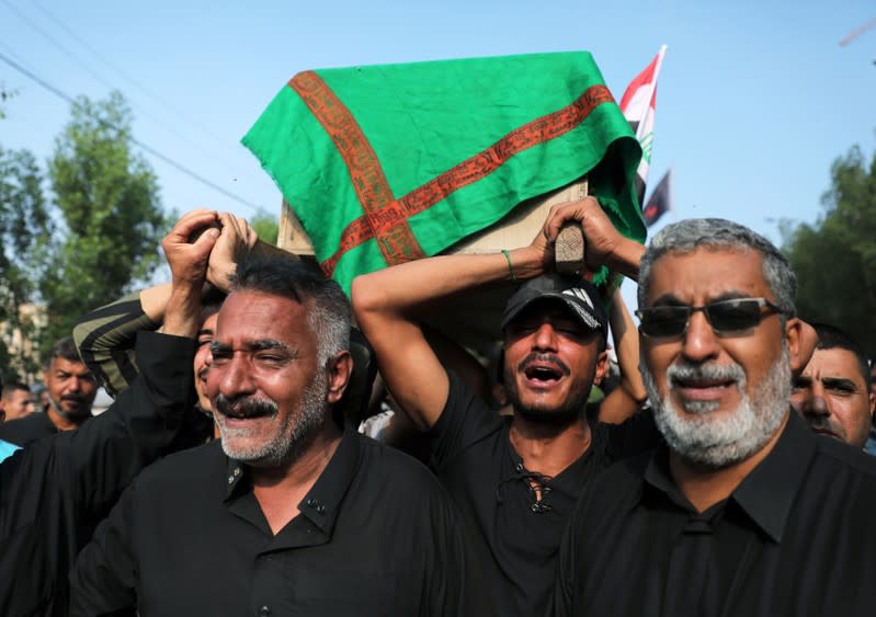 Mourners carry the coffin of a protester, who was killed overnight at protests in Kerbala, during a funeral in the holy city of Kerbala